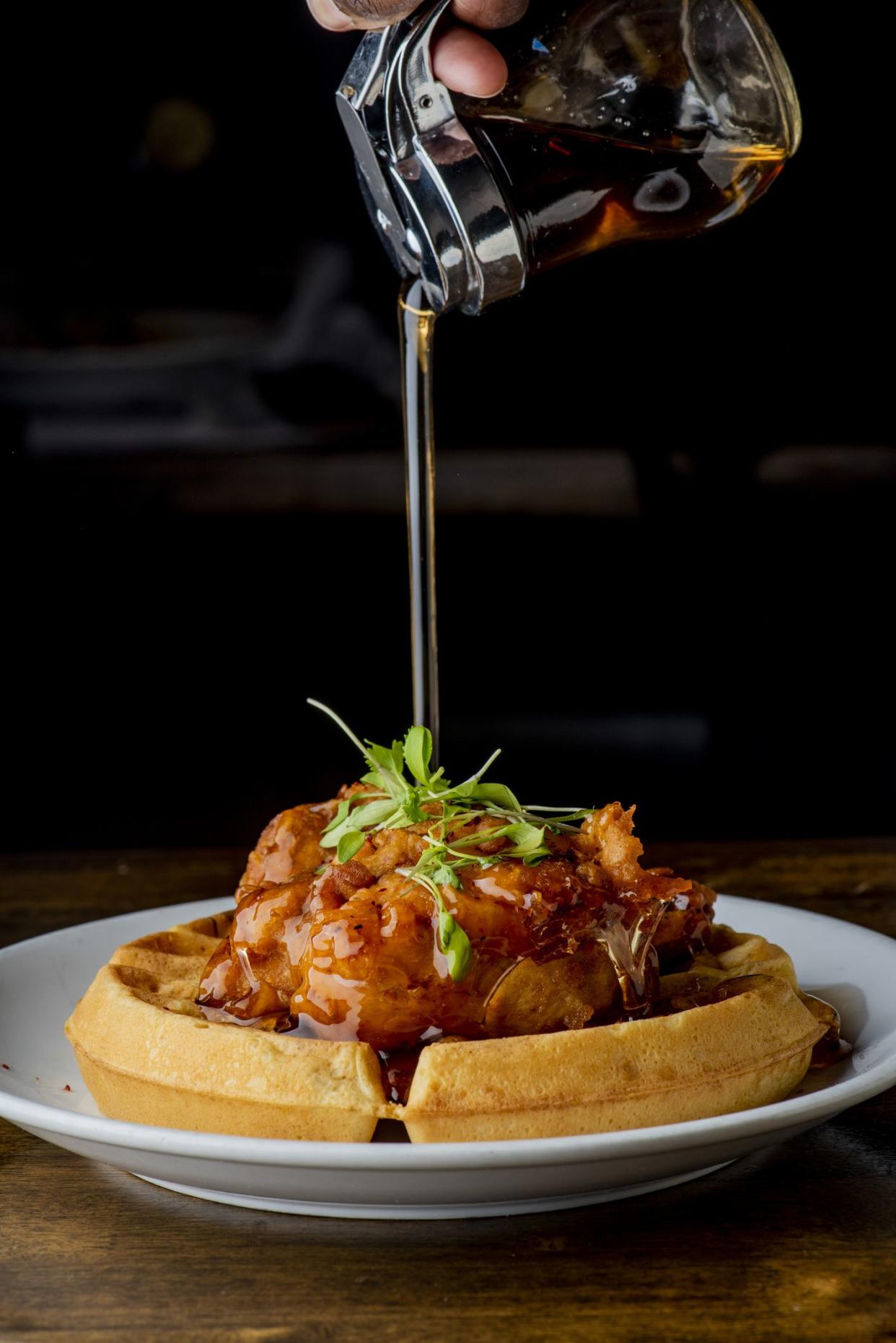 Chicken and waffles. Homemade waffles with crispy southern fried chicken, butter and maple syrup. Classic American breakfast or brunch favorite. Made from scratch waffles served with butter and maple syrup.