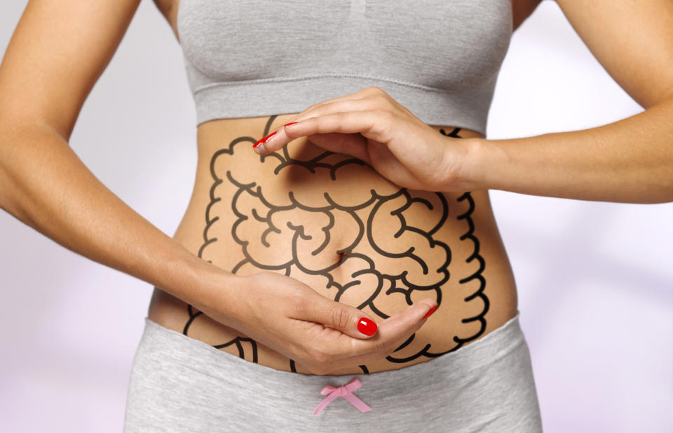 intestines drawn on a woman's abdomen representing digestion