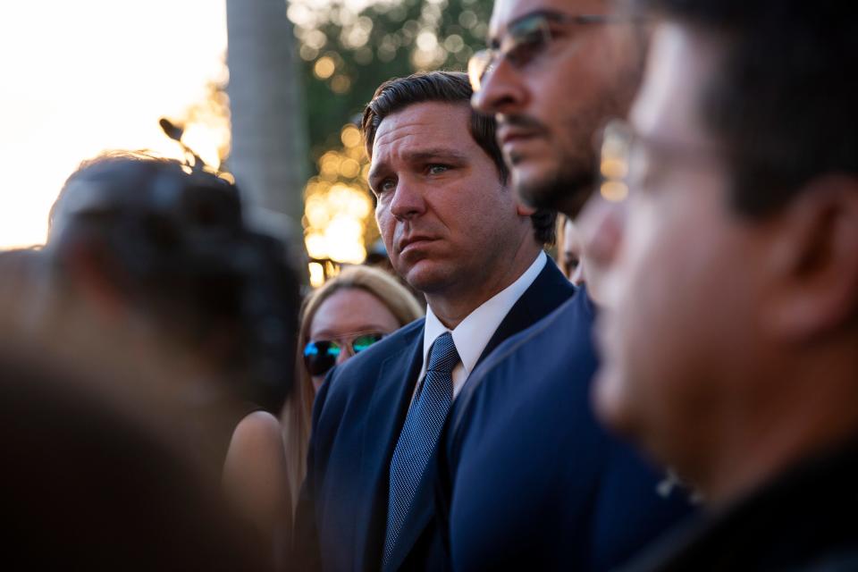 Governor Ron DeSantis listens to speakers during an interfaith vigil at Pine Trails Park in Parkland, Florida, on Thursday, February 14, 2019. 