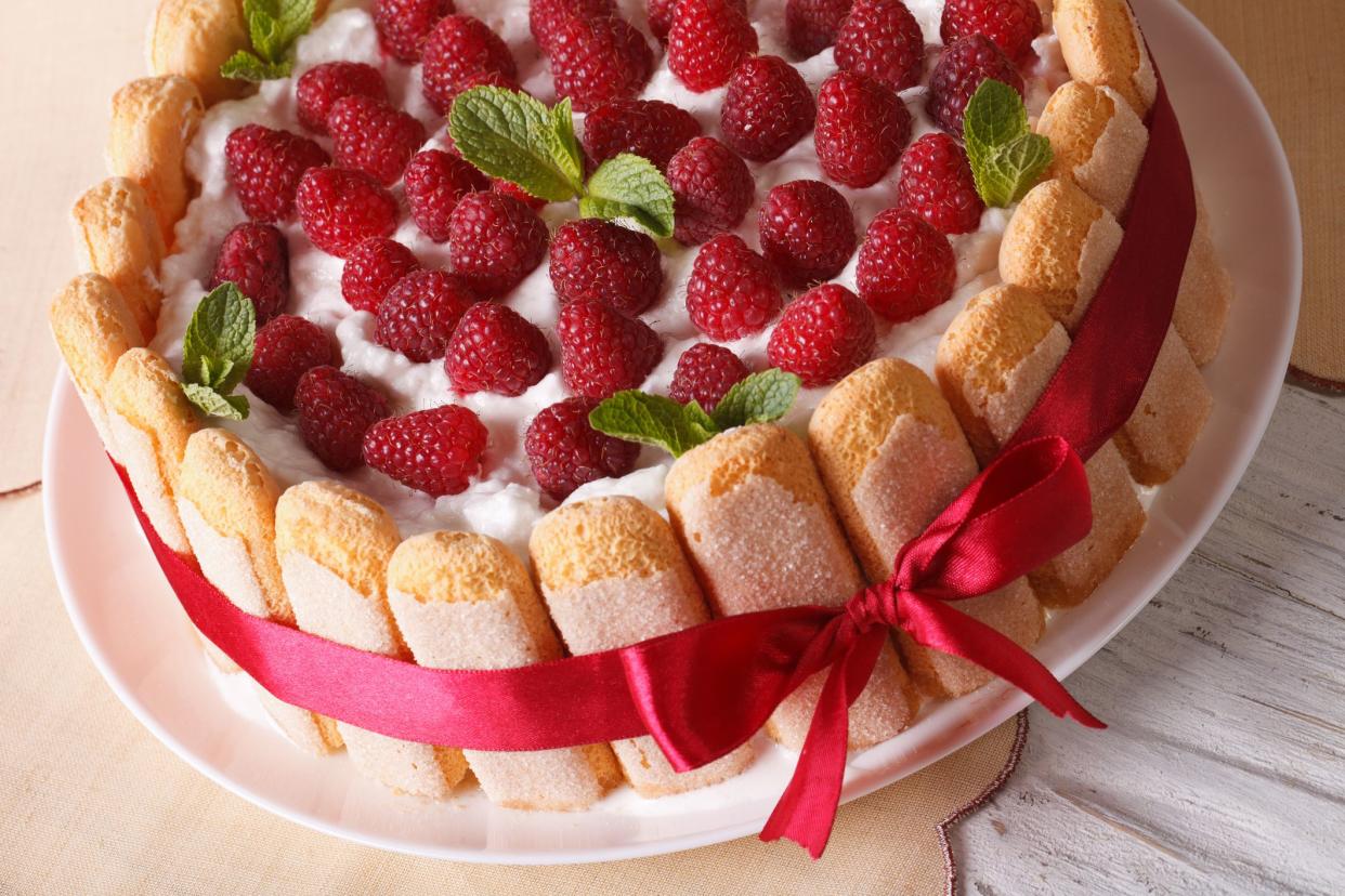 raspberry charlotte cake with Savoiardi close-up on the table. horizontal