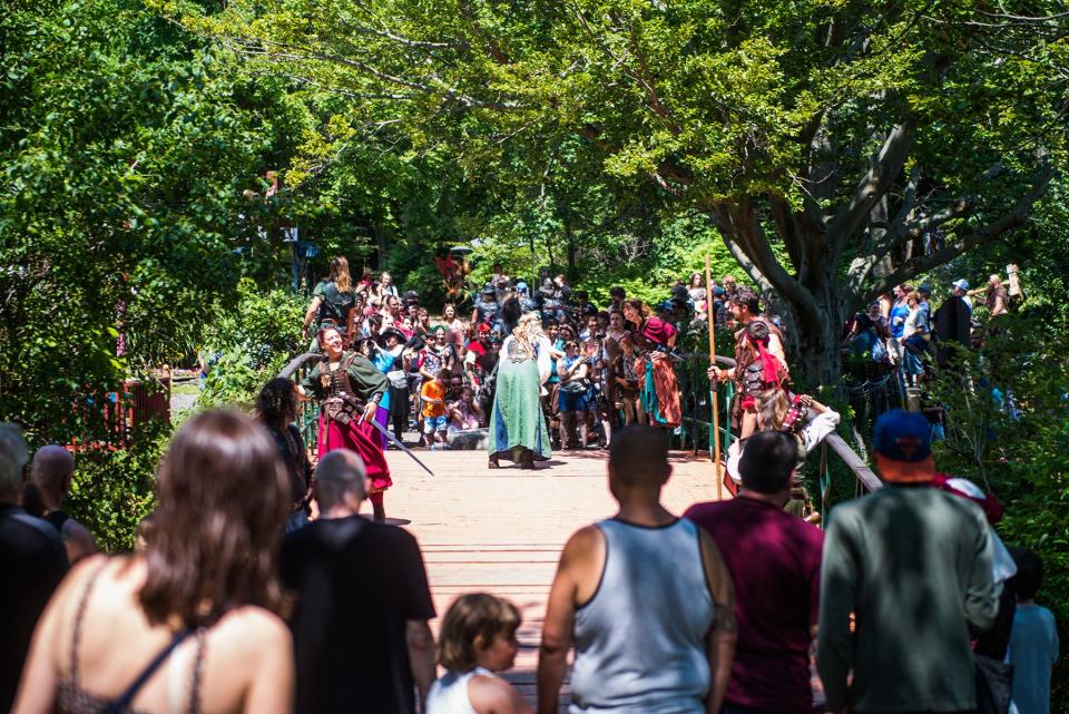 Maid Marian and Robin Hood talk on the bridge after a confrontation with the Sheriff Nottingham at the New York Renaissance Faire in Tuxedo.