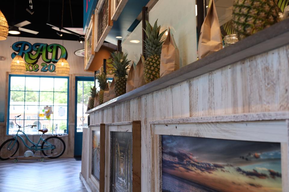 Inside new East Memphis acai bowl restaurant Playa Bowls, opening Saturday, May 11, 2024. The pineapples and seaside paintings give off the intended tropical, beachside vibe.
