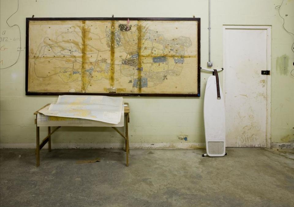 A table with a map on it, and an ironing board, inside the Corsham bunker.