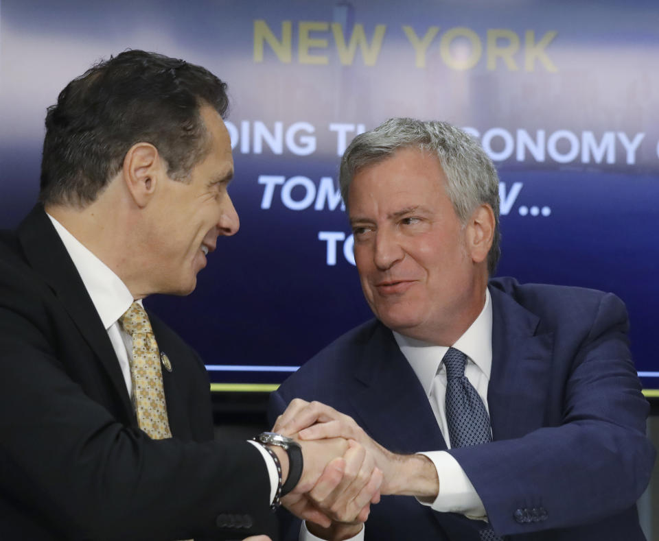 New York Gov. Andrew Cuomo, left, and New York City Mayor Bill de Blasio shake hands during a news conference Tuesday Nov. 13, 2018, in New York. Amazon said it will split its much-anticipated second headquarters between New York and northern Virginia. Its New York location will be in the Long Island City neighborhood of Queens. (AP Photo/Bebeto Matthews)