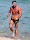 <p>Luke Evans takes a dip in the ocean in Miami on Dec. 8.</p>