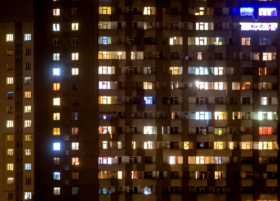 Lights on in an apartment building in Frankfurt, Germany, Monday, Dec. 14, 2020, two days before the country heads into a hard lockdown that will shut most stores, tighten social distancing rules and close schools across the country. (AP Photo/Michael Probst)
