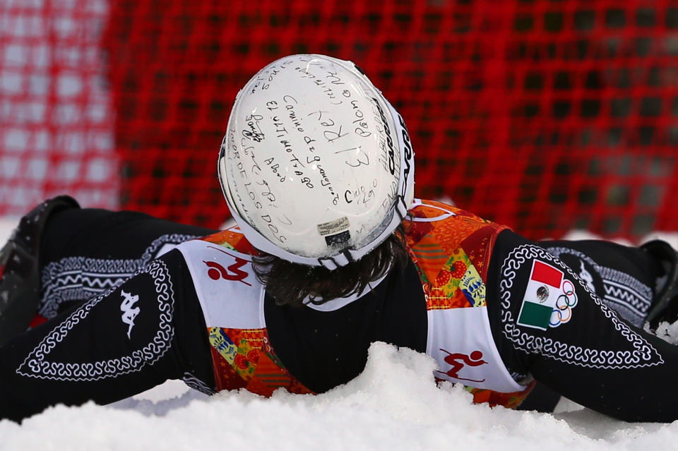 Mexico's Hubertus von Hohenlohe wears handwritten messages on his helmet as he crashes during the first run of the men's slalom at the Sochi 2014 Winter Olympics, Saturday, Feb. 22, 2014, in Krasnaya Polyana, Russia. (AP Photo/Alessandro Trovati)