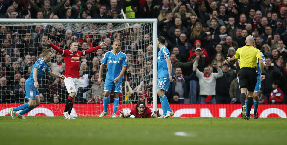Football: Manchester United's Radamel Falcao after being fouled in the box by Sunderland's John O'Shea resulting in a penalty but referee Roger East mistakenly shows a red card to Wes Brown