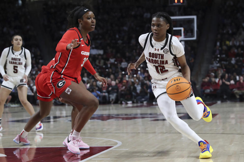 South Carolina guard MiLaysia Fulwiley (12) drives to the basket past Georgia forward Amiya Evans (30) during the first half of an NCAA college basketball game, Sunday, Feb. 18, 2024, in Columbia, S.C. (AP Photo/Artie Walker Jr.)