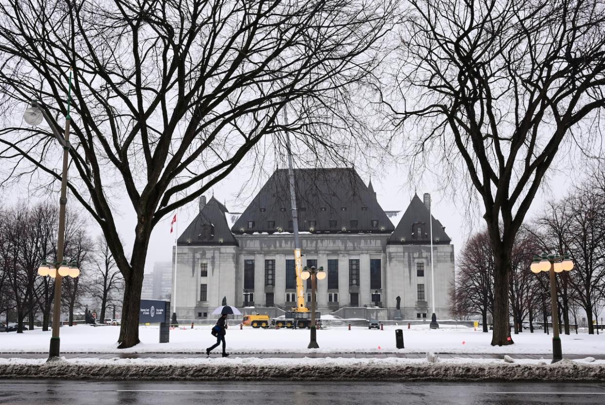 A pedestrian walks past the Supreme Court of Canada in Ottawa Nov. 26, 2020.  (Sean Kilpatrick/Canadian Press - image credit)