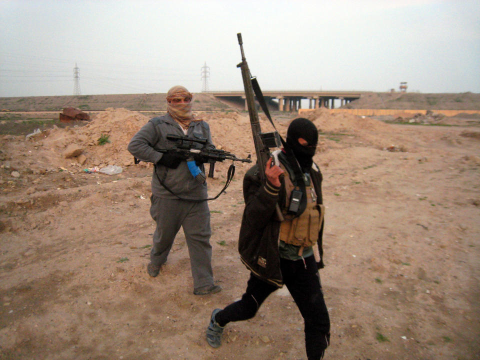 In this Thursday, Jan. 23, 2014 photo, gunmen prepare to take up combat positions in Fallujah, Iraq. Islamic militants controlling a mainly Sunni area west of Baghdad are so well-armed that they could occupy the capital, members of Iraq's al-Qaida branch - known as the Islamic State of Iraq and the Levant - have taken over parts of Ramadi, the capital of the largely Sunni western province of Anbar. (AP Photo)