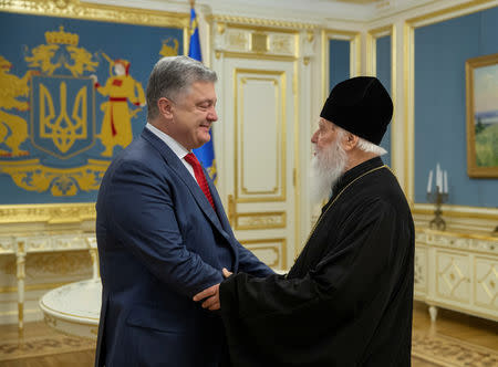 FILE PHOTO: Ukraine's President Petro Poroshenko (L) meets with Patriarch Filaret, head of the Ukrainian Orthodox Church of the Kiev Patriarchate, in Kiev, Ukraine October 11, 2018. Mykhailo Markiv/Ukrainian Presidential Press Service/Handout via REUTERS