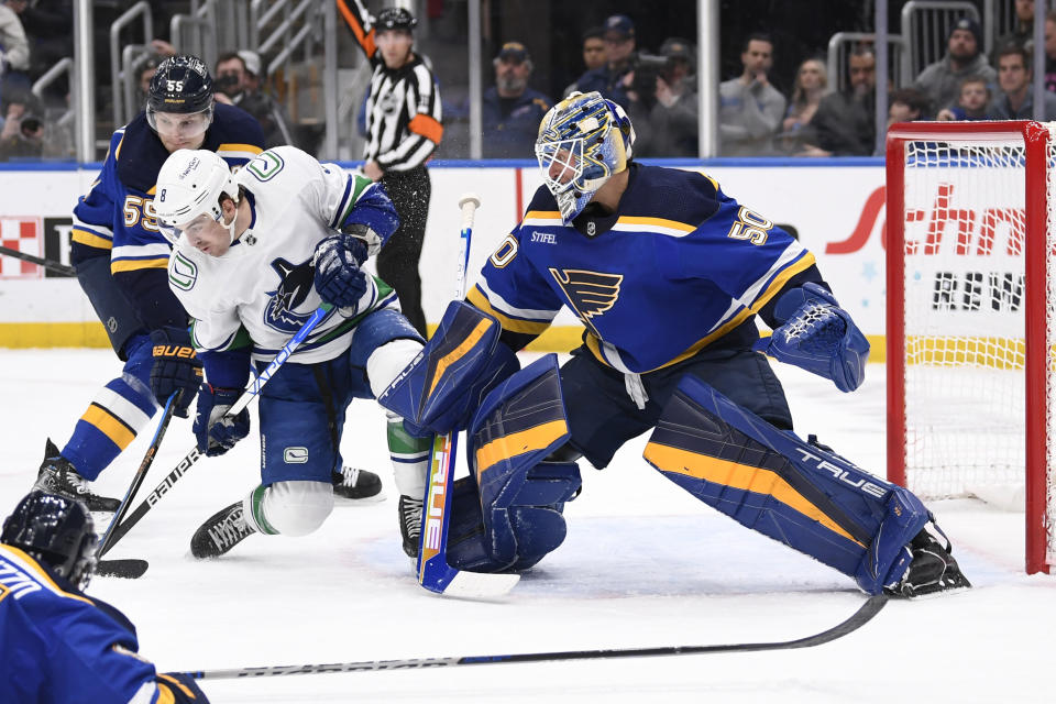 Vancouver Canucks right wing Conor Garland (8) is called for goaltender interference against St. Louis Blues goaltender Jordan Binnington (50) during the first period of an NHL hockey game Thursday, Feb. 23, 2023, in St. Louis. (AP Photo/Jeff Le)