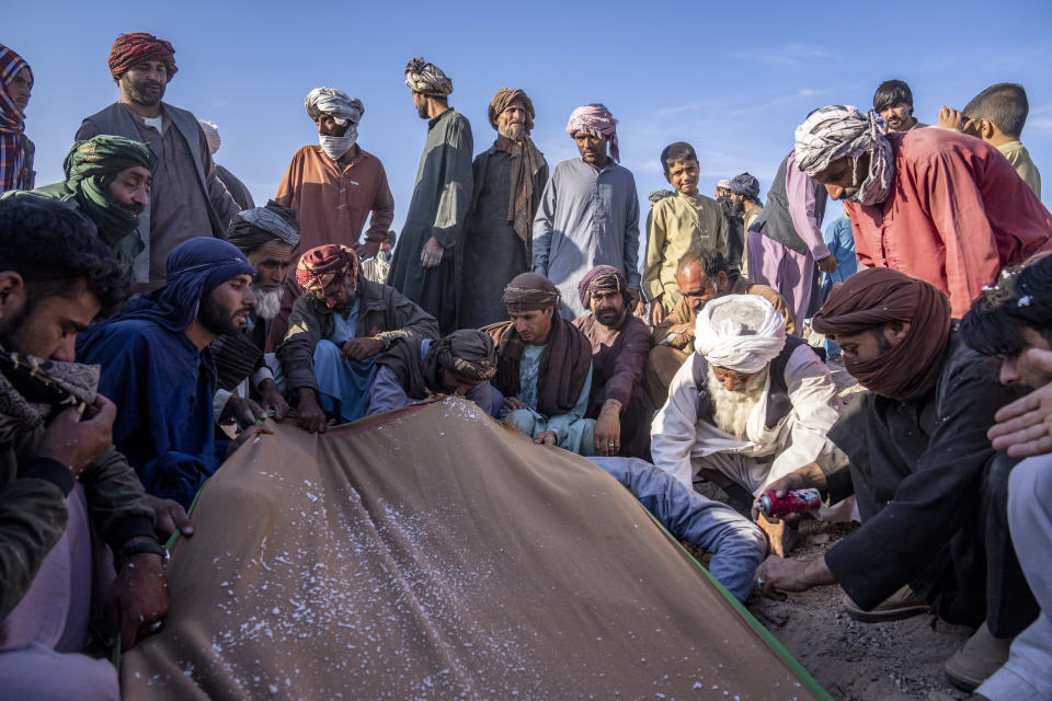 Afghans bury relatives killed in an earthquake at a burial site in Zenda Jan district in Herat province, western of Afghanistan, Monday, Oct. 9, 2023. Saturday's deadly earthquake killed and injured thousands when it leveled an untold number of homes in Herat province. (AP Photo/Ebrahim Noroozi)