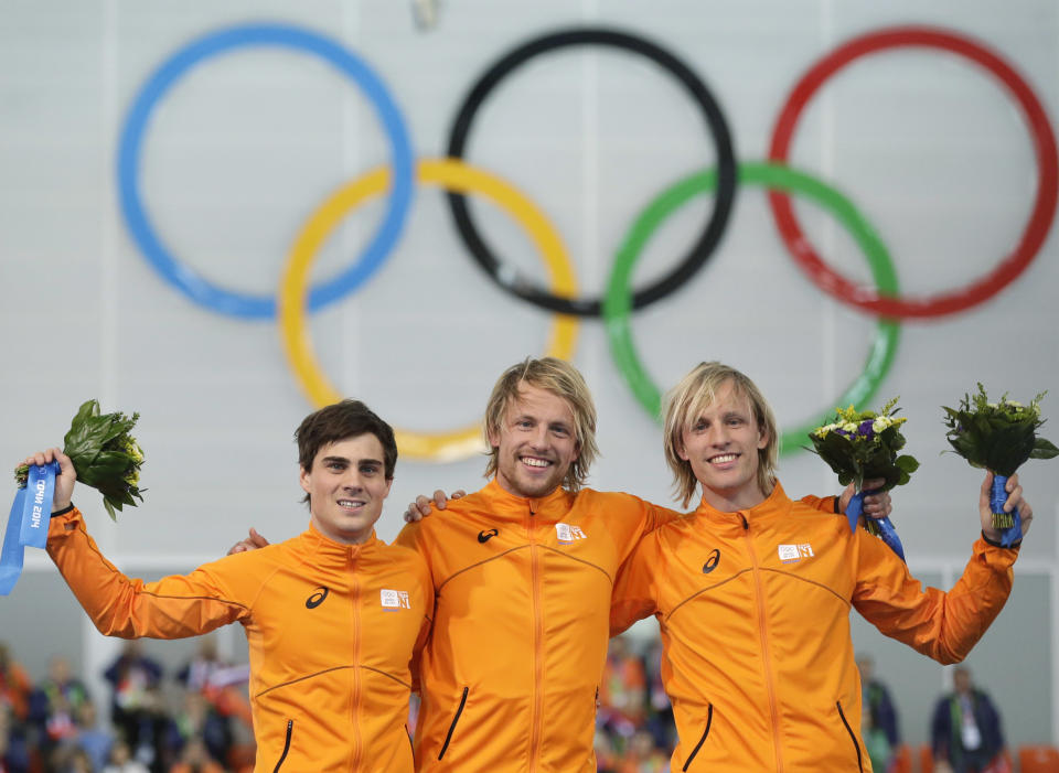 Athletes from the Netherlands, from left to right, Silver medallist Jan Smeekens, gold medallist Michel Mulder and bronze medallist Ronald Mulder stand on the podium during the flower ceremony for the men's 500-meter speedskating race at the Adler Arena Skating Center at the 2014 Winter Olympics, Monday, Feb. 10, 2014, in Sochi, Russia. (AP Photo/Patrick Semansky)