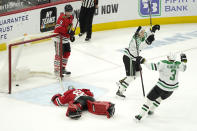 Dallas Stars' Jason Robertson (21) celebrates his winning goal with John Klingberg (3) as Chicago Blackhawks goaltender Collin Delia and Connor Murphy (5) look on during the overtime period of an NHL hockey game Monday, May 10, 2021, in Chicago. (AP Photo/Charles Rex Arbogast)