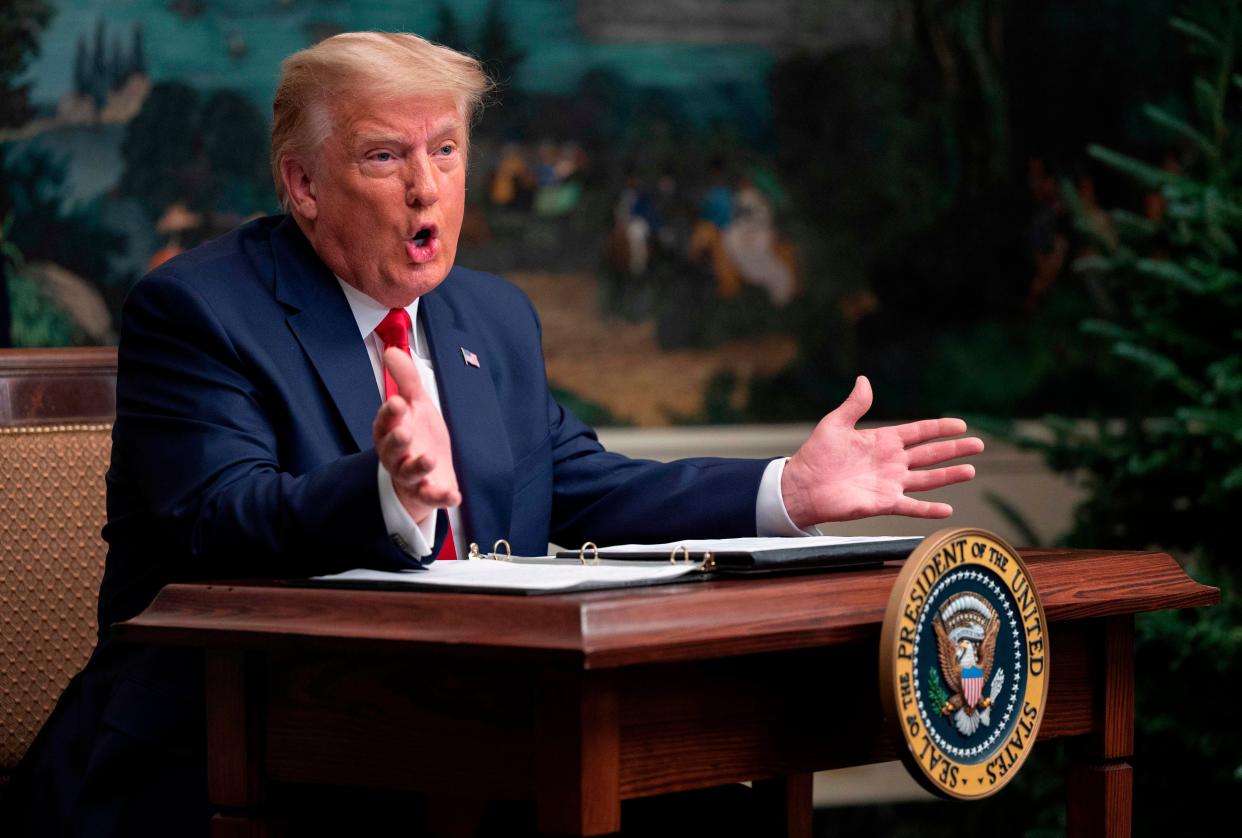 Donald Trump speaks to reporters after participating in a Thanksgiving teleconference with members of the United States Military (AFP via Getty Images)