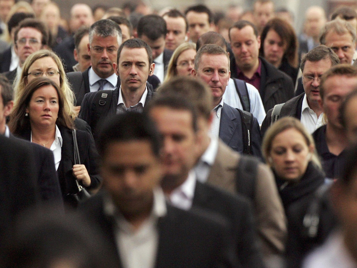 Commuters walk to work over London Bridge: Getty