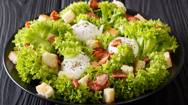 salade Lyonnaise on black plate