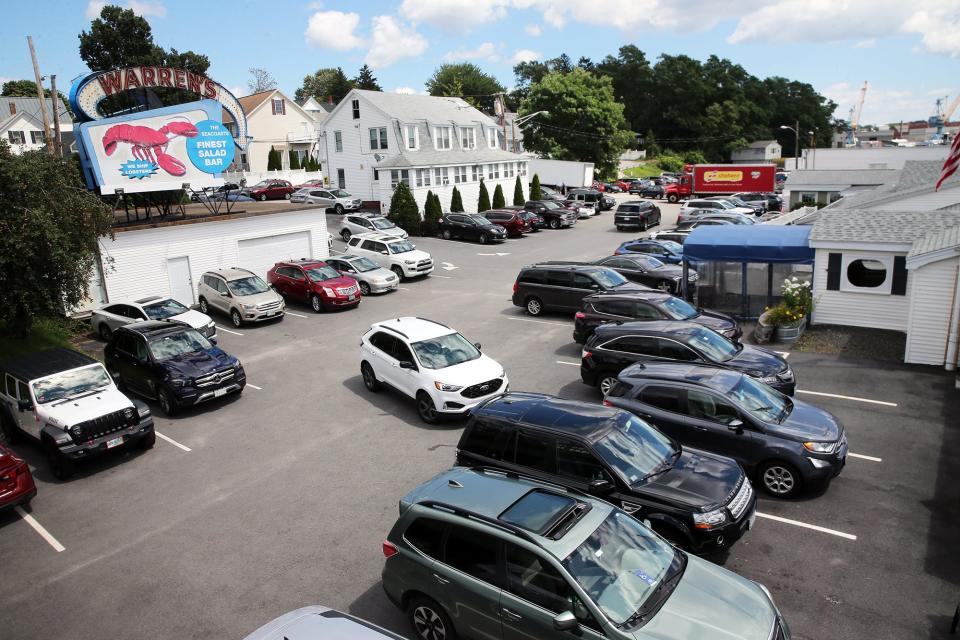 Lunch goers drive around a full parking lot searching for a space at Warren's Lobster House in Kittery Aug. 11, 2023.