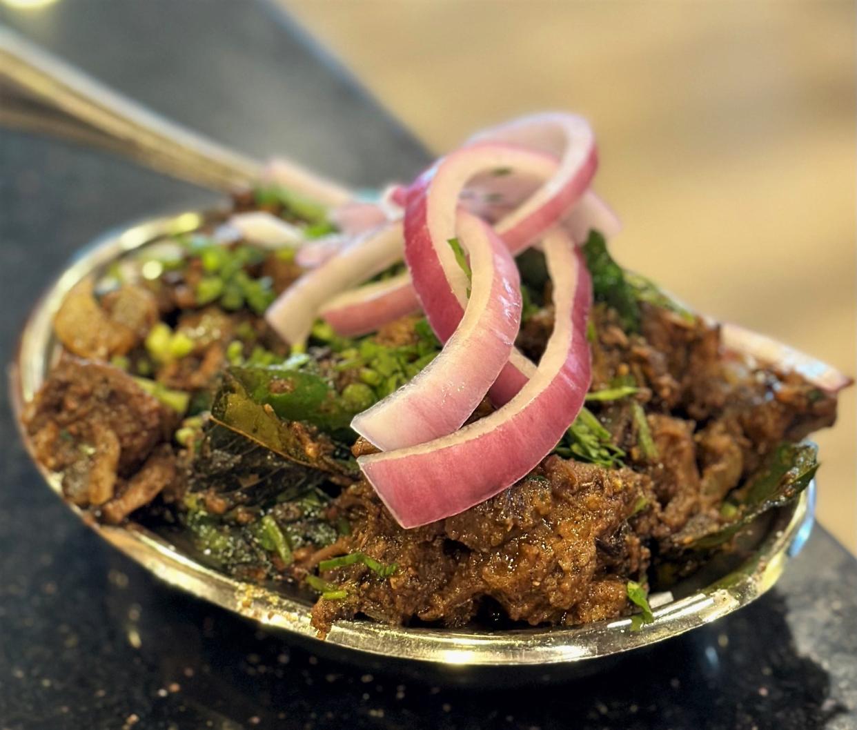 The boneless lamb stir fry at Sangam Chettinad is a riot of flavors.
