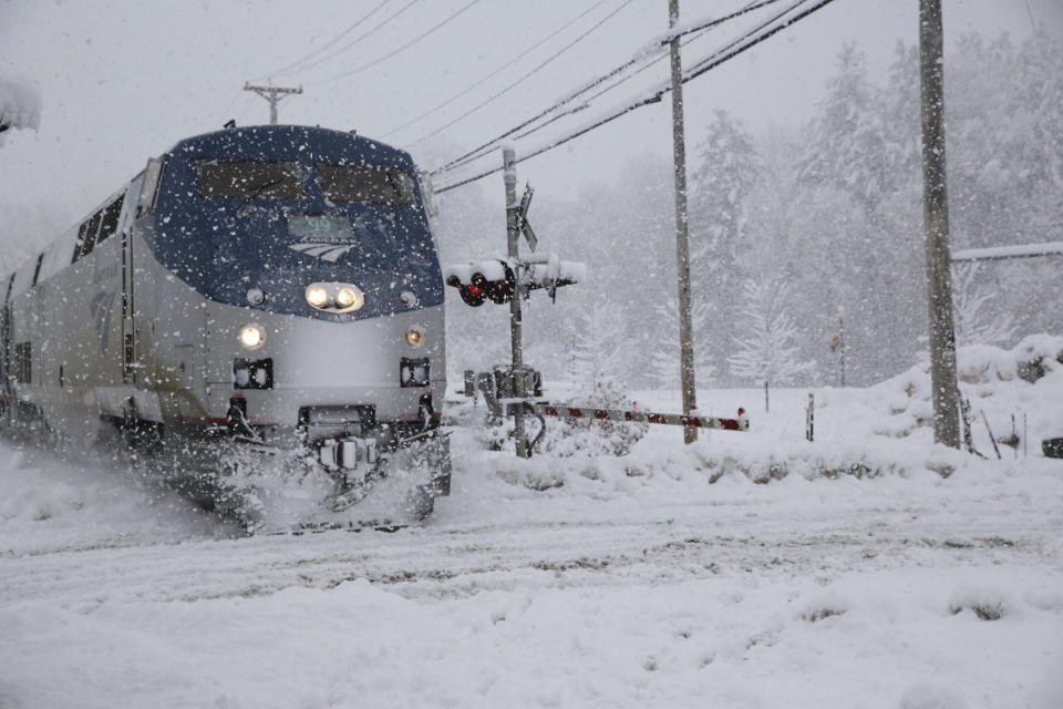 The southbound Amtrak Vermonter arrives at the station in Waterbury, Vt., during a snowstorm on Tuesday, March 14, 2023. The train was traveling during a winter storm that was dropping heavy, wet snow across the Northeast. The storm caused a plane to slide off a runway, led to hundreds of school closings, canceled flights and thousands of power outages in parts of the Northeast on Tuesday. (AP Photo/Wilson Ring)