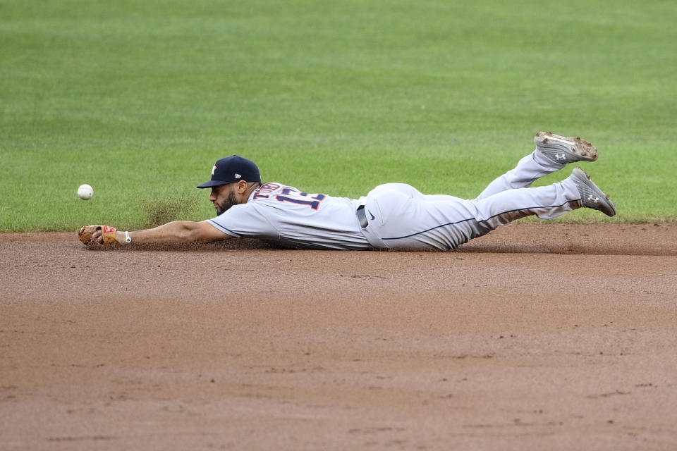 Houston Astros third baseman Abraham Toro misses a ball hit for a single by Baltimore Orioles' Freddy Galvis, not seen, during the first inning of a baseball game, Tuesday, June 22, 2021, in Baltimore. (AP Photo/Nick Wass)