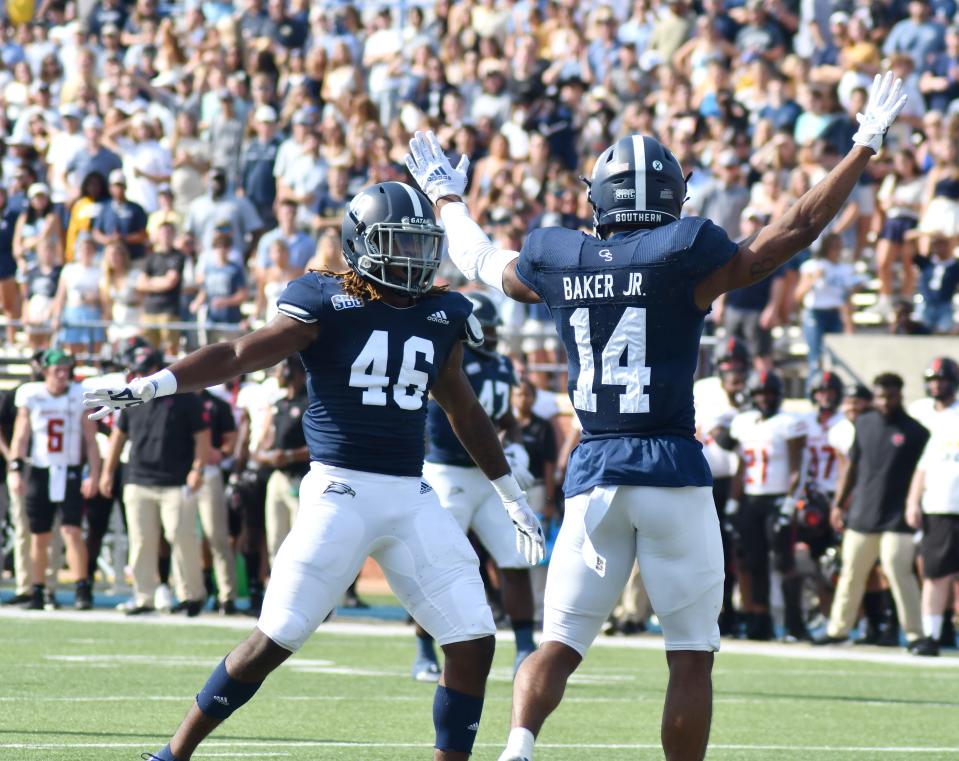 Georgia Southern defensive players Darrell Barker Jr. and Eldrick Robinson III celebrate after making a stop of the Arkansas State offense in Statesboro Saturday in the Sun Belt contest.