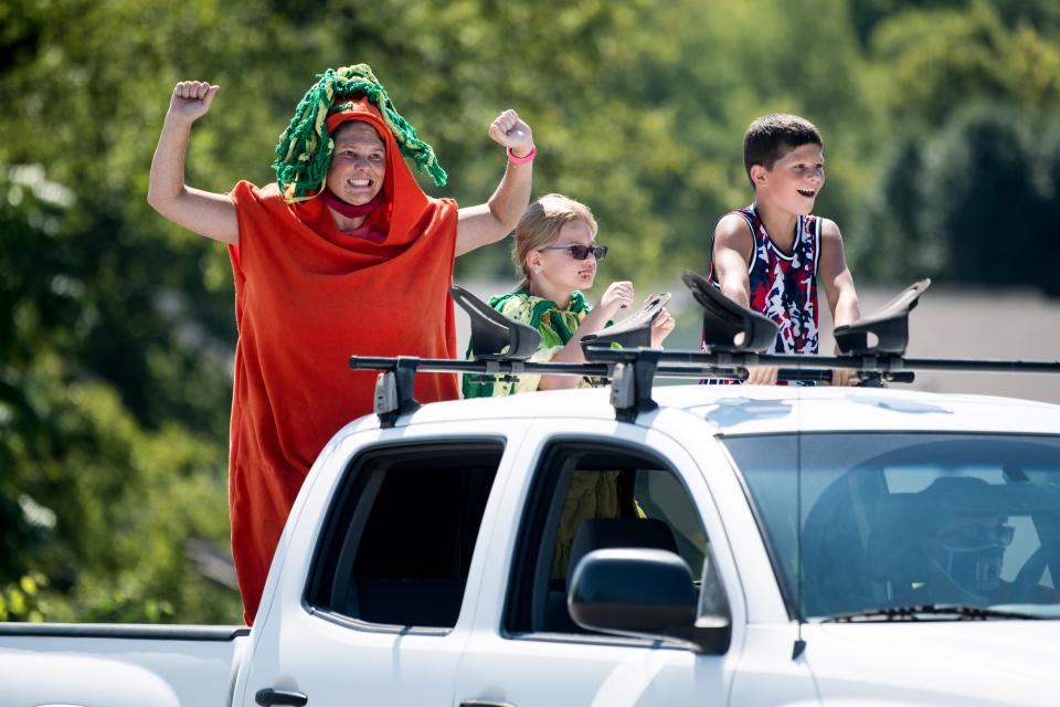 Vehicles pass by during the Tomato Art Fest Porch Parade in the East Nashville. This year's event is scheduled for Aug. 11-12.