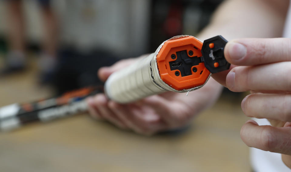 In this photo taken Friday June, 28, 2019, a tennis racquet handle is opened to show how information can be gathered electronically and used to enhance player performance, at the International Tennis Federation (ITF) lab in Roehampton, near Wimbledon south west London. Based for about 20 years in a three-room area on what used to be a pair of squash courts in Roehampton, the ITF tech lab is filled with more than $1 million worth of machines that help make sure rules are followed and parameters are met. (AP Photo/Alastair Grant)