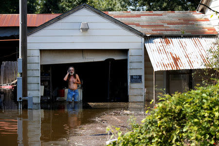 Kent Kirk looks out from his garage flooded by Tropical Storm Harvey in Rose City, Texas, U.S. on August 31, 2017. REUTERS/Jonathan Bachman