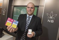 Brian Harriman, Cannabis NB president and CEO, shows some cannabis products at a Cannabis NB retail store in Fredericton, New Brunswick, Tuesday, Oct. 16, 2018. (Stephen MacGillivray/The Canadian Press via AP)