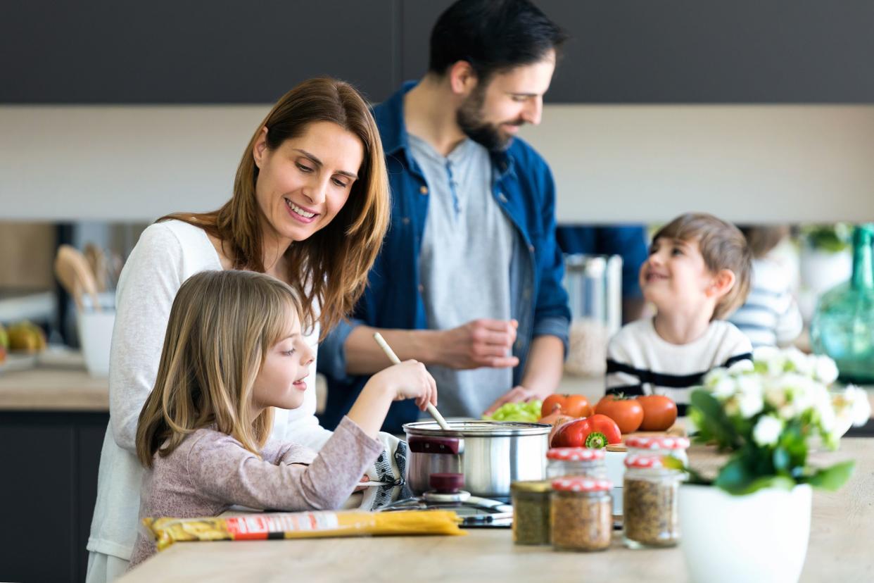 family having fun while cooking together in the kitchen at home