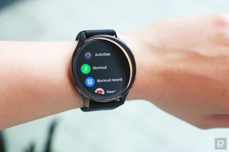 <p>OnePlus Watch review photos. OnePlus Watch on a wrist with display showing a list of apps including Activities, Workout, Workout record and Heart...</p>
