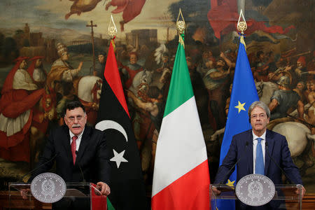 Italian Prime Minister Paolo Gentiloni (R) listens to his Libyan counterpart Fayez al-Sarraj during a news conference at Chigi Palace in Rome, Italy, July 26, 2017. REUTERS/Max Rossi