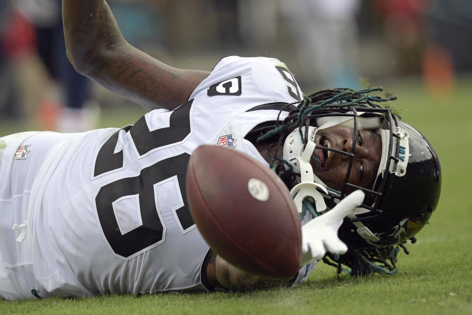 Jacksonville Jaguars cornerback Shaquill Griffin (26) can't quite hang on to a possible interception during the first half of an NFL football game against the Denver Broncos, Sunday, Sept. 19, 2021, in Jacksonville, Fla. (AP Photo/Phelan M. Ebenhack)