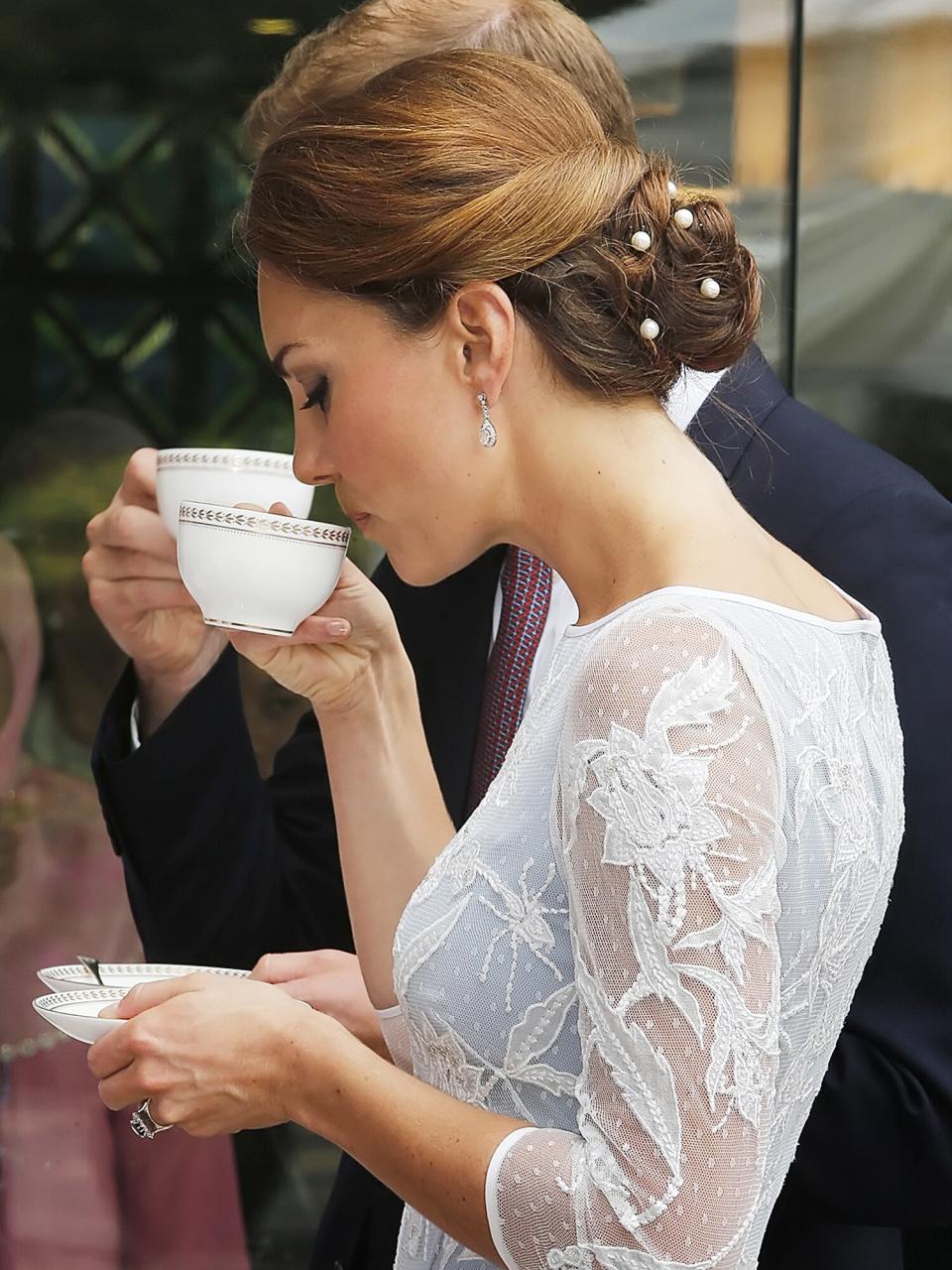 Catherine, Duchess of Cambridge drinks tea at the British High Commission on day 4 of Prince William, Duke of Cambridge and Catherine, Duchess of Cambridge's Diamond Jubilee Tour of the Far East on September 14, 2012 in Kuala Lumpur, Malaysia
