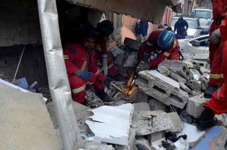 Firefighters search for the bodies of civilians who were killed after an air strike against Islamic State triggered a massive explosion in Mosul, Iraq, March 22, 2017. Picture taken March 22, 2017. REUTERS/Stringer