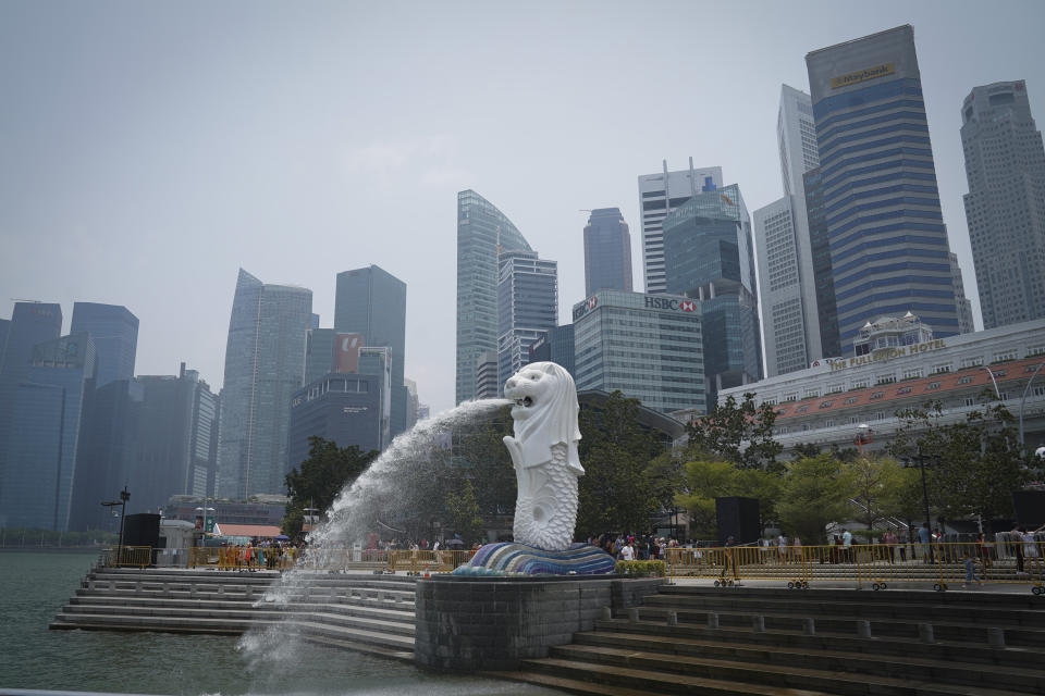 In this picture taken Saturday, Sept, 21, 2019, show Merlion statue with the background of business district in Singapore. Singaporean Prime Minister Lee Hsien Loong is calling for new elections to seek a new mandate during the coronavirus pandemic. (AP Photo/Vincent Thian)