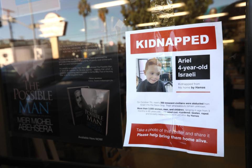 A flier with a child's photo says "Kidnapped: Ariel. 4-year-old. Israeli."