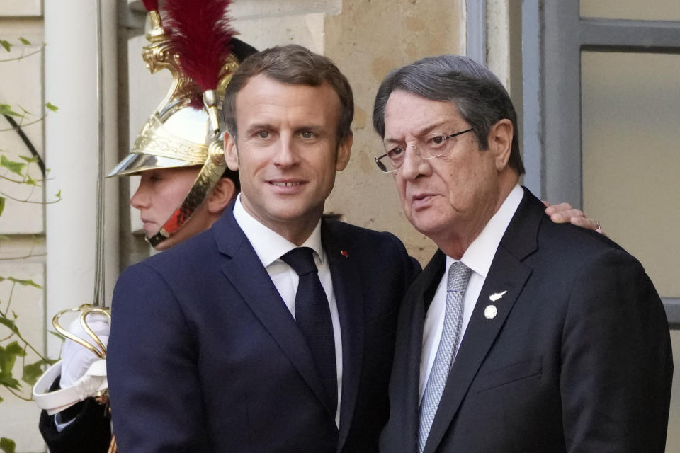 France's President Emmanuel Macron, left, and President of Cyprus Nicos Anastasiades pose before a conference with several world leaders in Paris, Friday, Nov. 12, 2021. France is hosting an international conference on Libya on Friday as the North African country is heading into long-awaited elections next month. (AP Photo/Francois Mori)