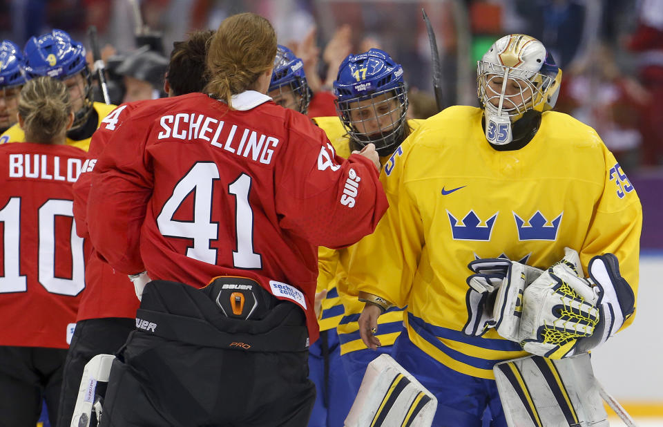 Goalkeeper Valentina Wallner of Sweden (35) congratulates goalkeeper Florence Schelling of Switzerland (41) after Switzerland beat Sweden 4-3 in the women's bronze medal ice hockey game at the 2014 Winter Olympics, Thursday, Feb. 20, 2014, in Sochi, Russia. (AP Photo/Mark Humphrey)