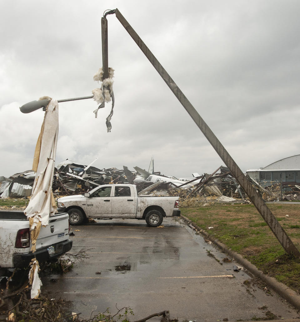 A light pole is damaged and draped with debris after a tornado Saturday, March 28, 2020, at Jonesboro Municipal Airport in Jonesboro, Ark. (Quentin Winstine/The Jonesboro Sun via AP)