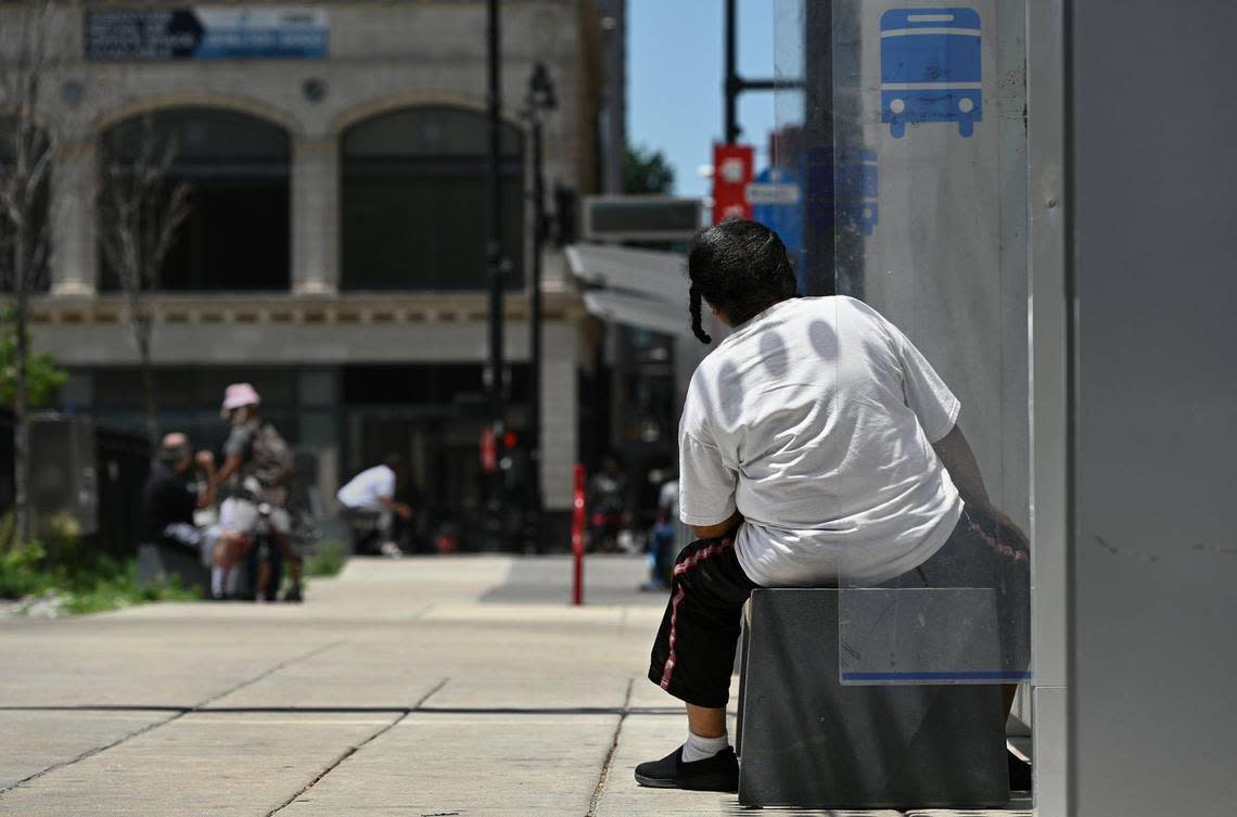 A passenger checks if a bus is approaching at the 12th Street and Grand Boulevard stop Monday, June 6, 2022.