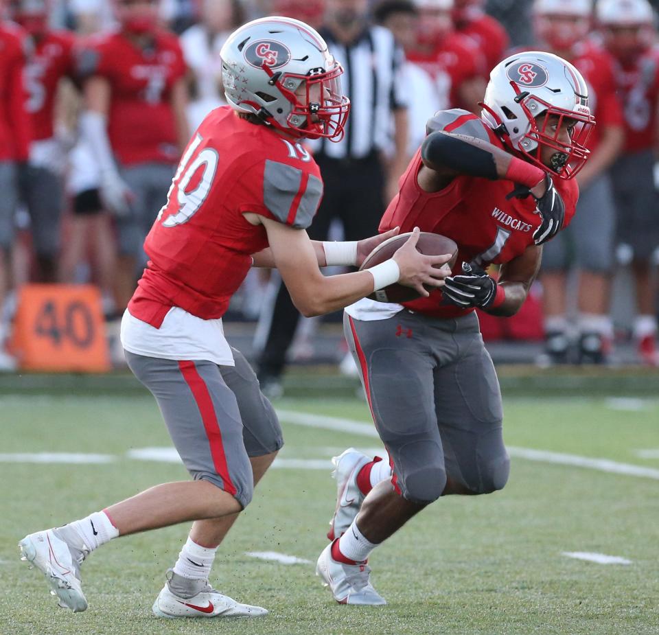 Poochie Snyder, 19, of Canton South fakes a handoff to Tam Church, 1, during their game at Canton South on Friday, Sept. 17, 2021.