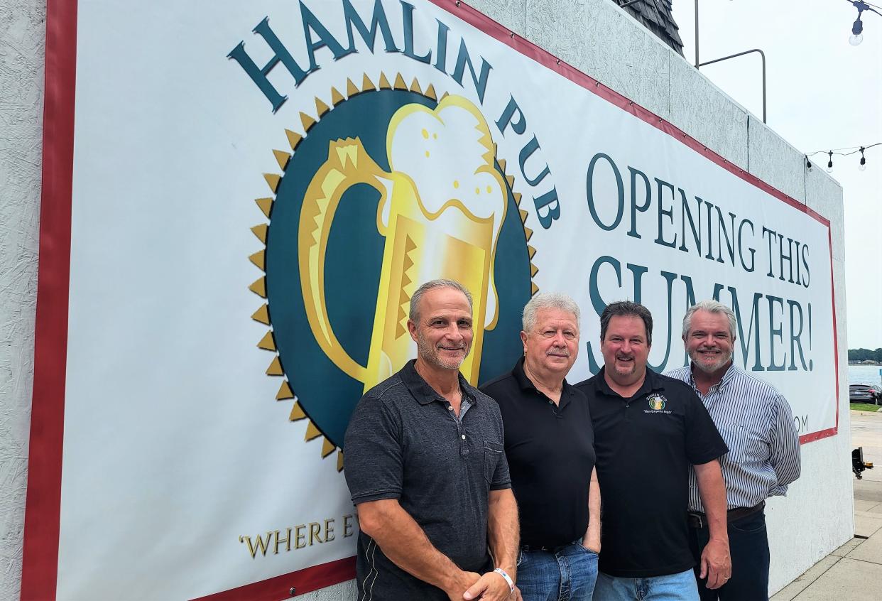 Robert Leger, John DeAngelis, Jim Tavano, and David Wirth, partners in the St. Clair Hamlin Pub location, stand outside the developing sports bar on Saturday, July 1, 2023.