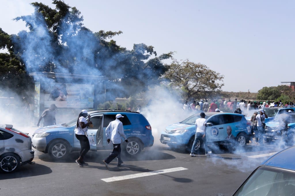 Senegalese riot police lobs tear gas at supporters of opposition presidential candidate Daouda Ndiaye, in Dakar, Senegal, Sunday, Feb. 4, 2024. (AP Photo/Stefan Kleinowitz)