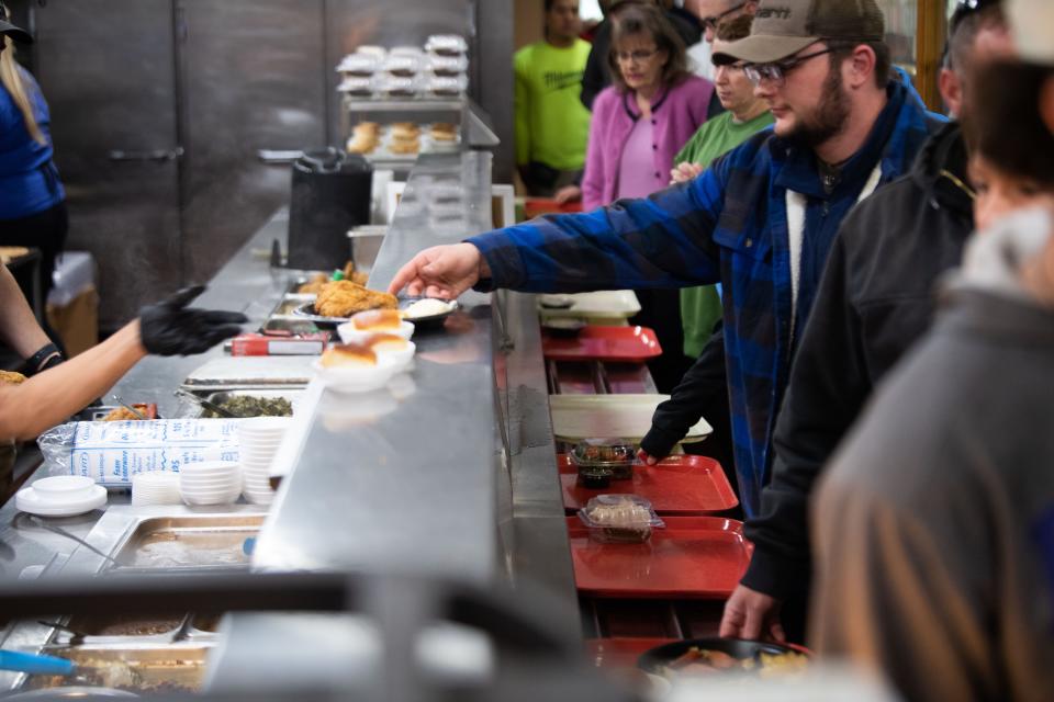 Brandon Safranek Jr. grabs his food at Arnold’s in Nashville, Tenn., Monday, Jan. 8, 2024.