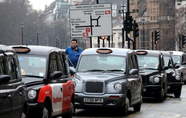 Taxi drivers line the street in Whitehall, London 