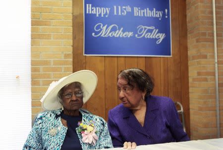 Jeralean Talley (L) sits at the head table with her friend Marian Allen during a celebration of her 115th birthday at the New Jerusalem Missionary Baptist Church in Inkster, Michigan May 25, 2014. REUTERS/Rebecca Cook